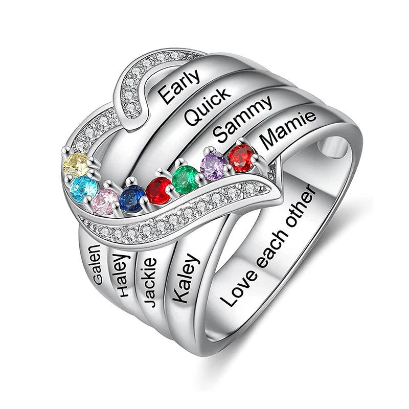 Silver ring with engraved names and colorful gemstones on a white background