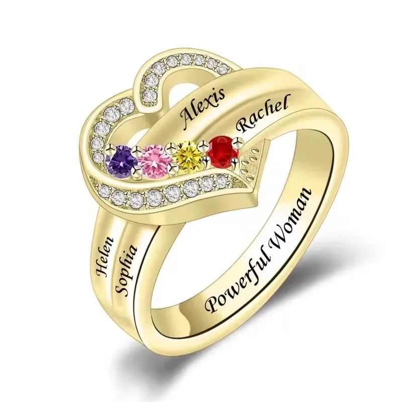 Gold heart-shaped ring with engraved names and colorful gemstones on a white background