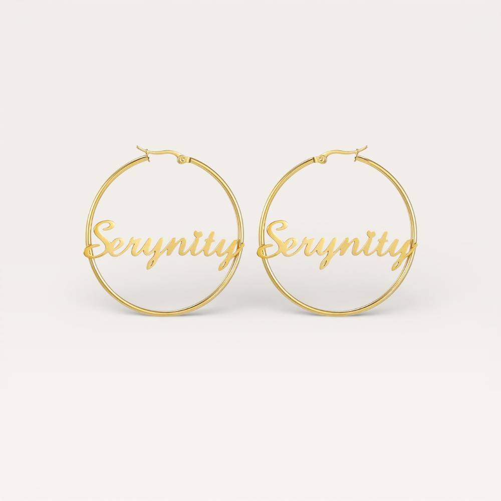 Gold hoop earrings with 'Serenity' engraving on a white background