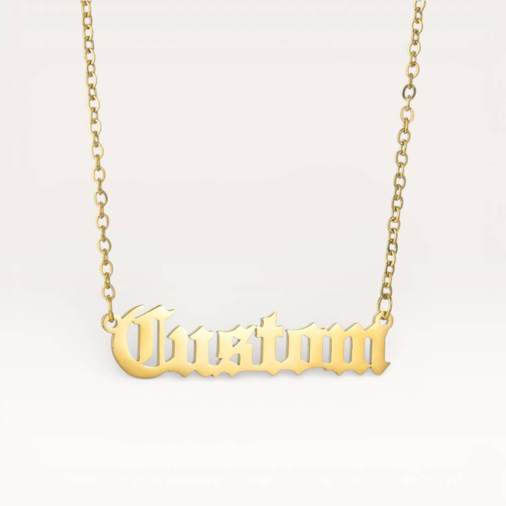 Gold 'Custom' necklace on a light gray background