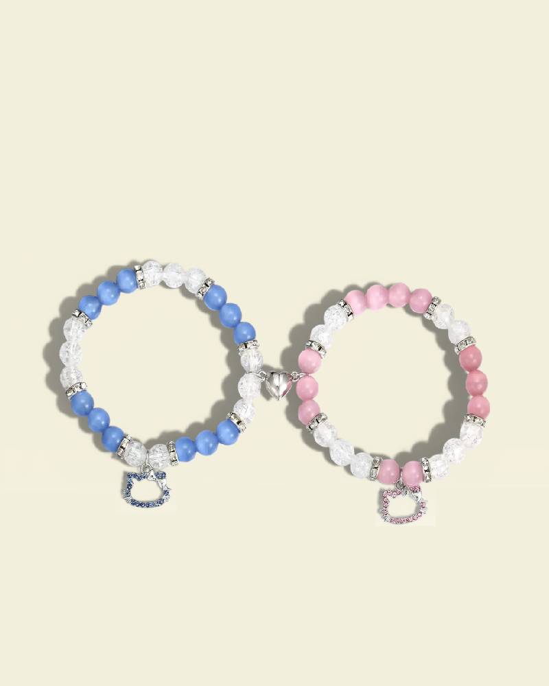 Two beaded bracelets with heart charms on a light beige background