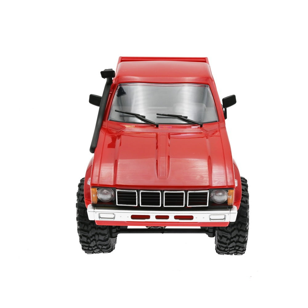 Complete RC truck set including red off-road truck, remote controller, charging cable, and 1/2/3 green battery packs
