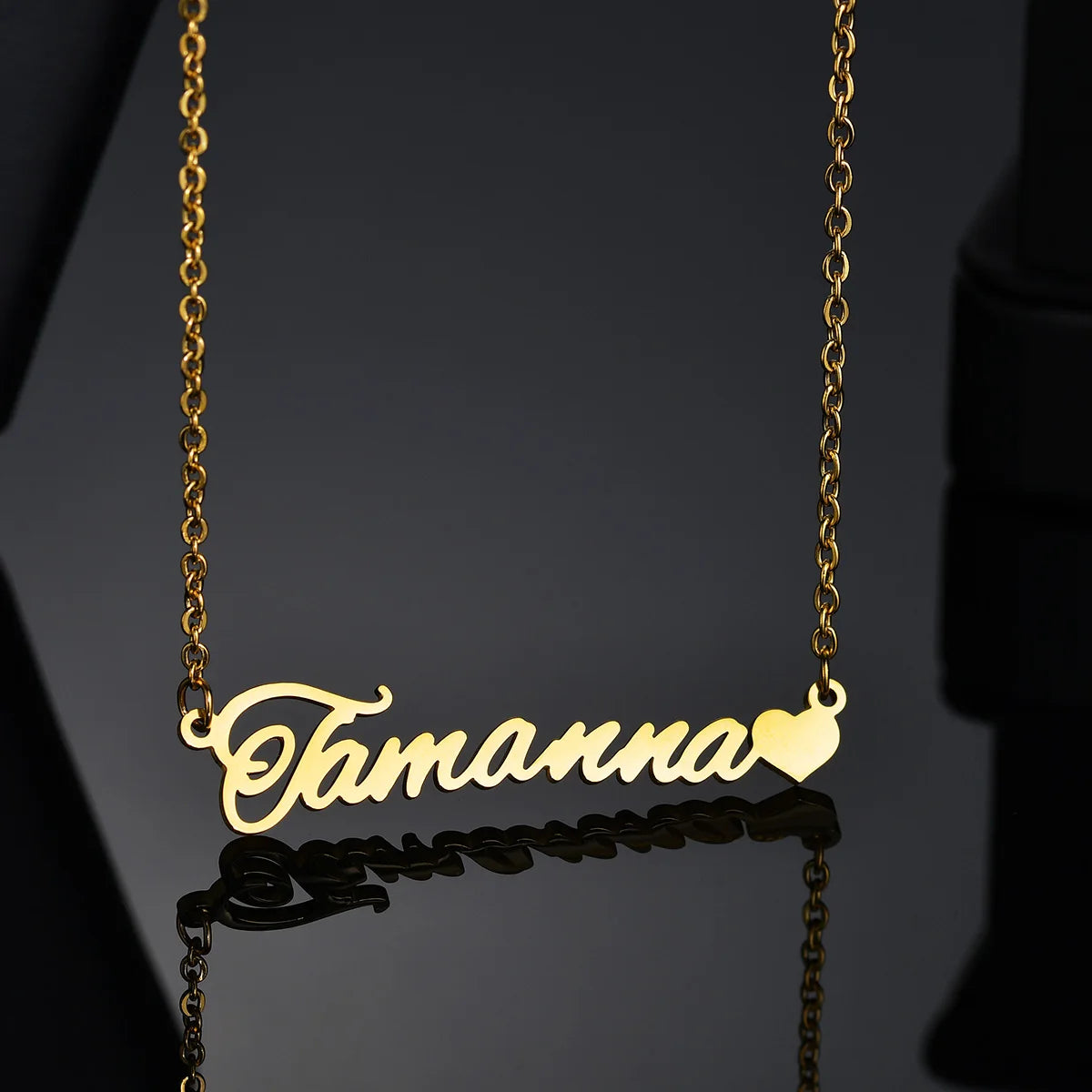 Gold name necklace with 'Tamanna' on a black background