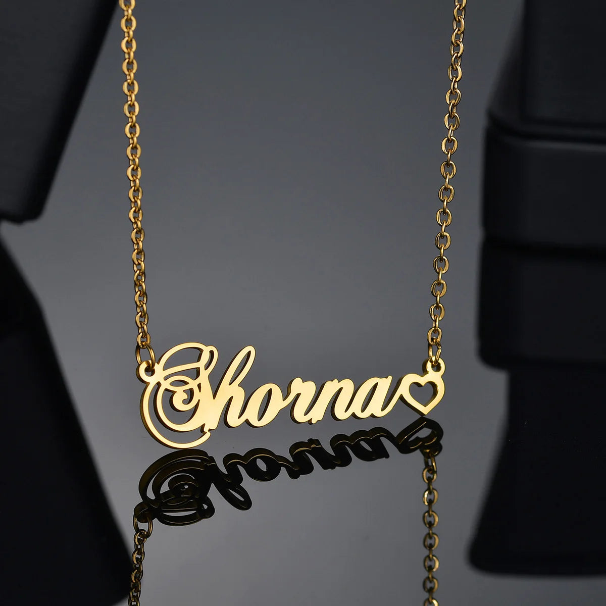 Gold name necklace with 'Shanna' on a dark background