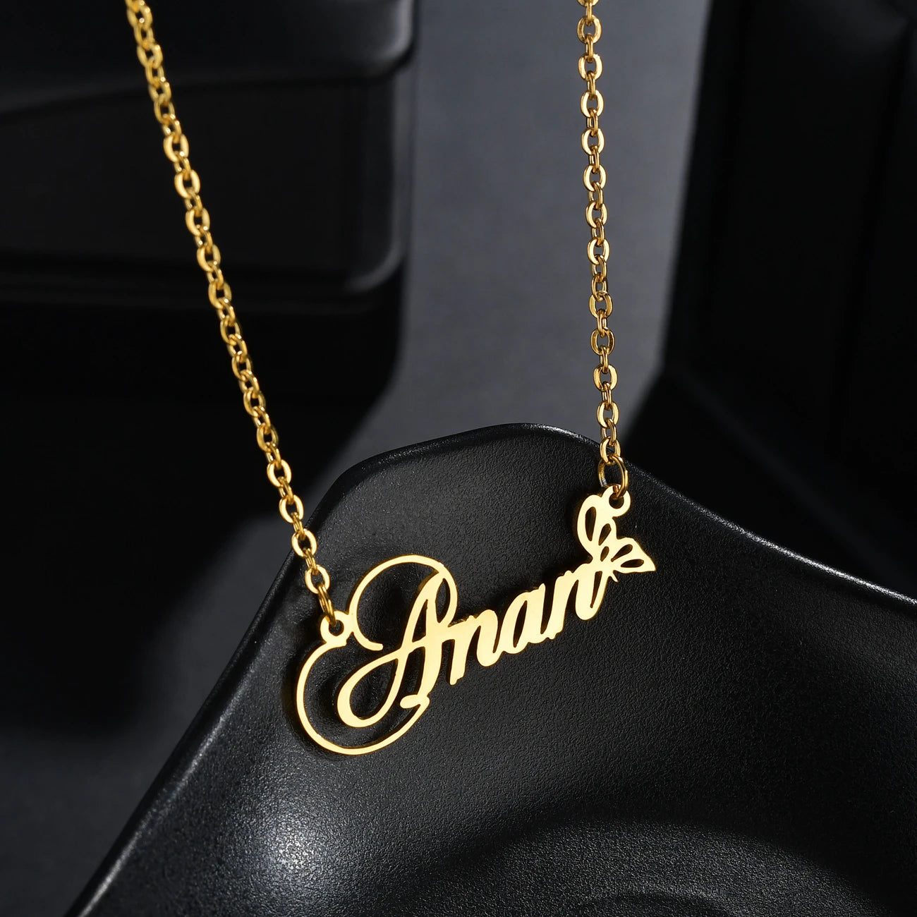 Gold name necklace on a black background