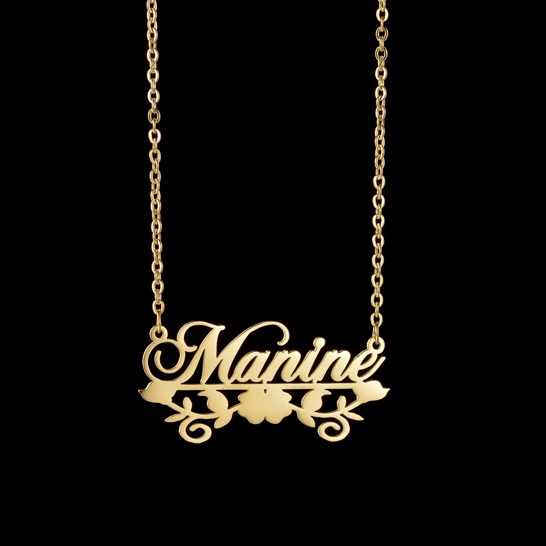 Gold necklace with 'Manine' pendant on a black background