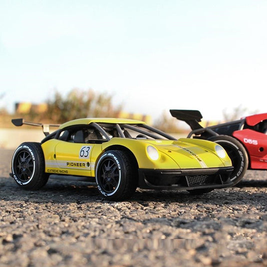Yellow toy car with 'Pioneer' branding on a dirt track