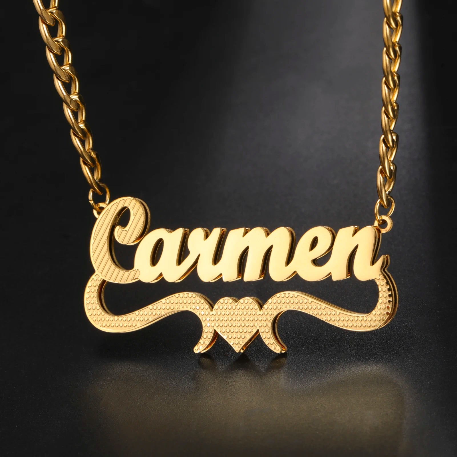 Gold necklace with 'Carmen' pendant on a dark background