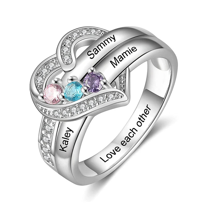 Silver ring with engraved names and colorful gemstones on a white background