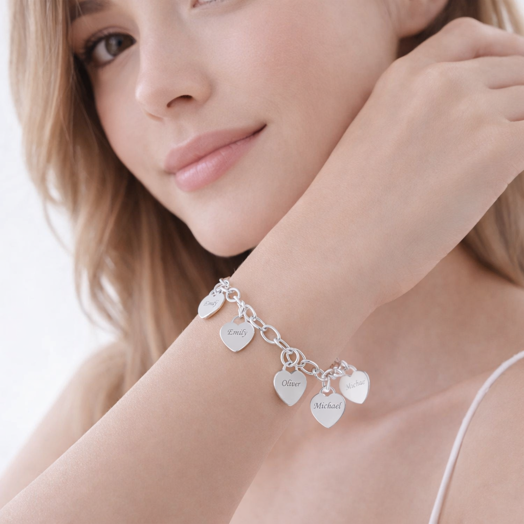 Woman wearing a silver bracelet with heart-shaped charms on a white background