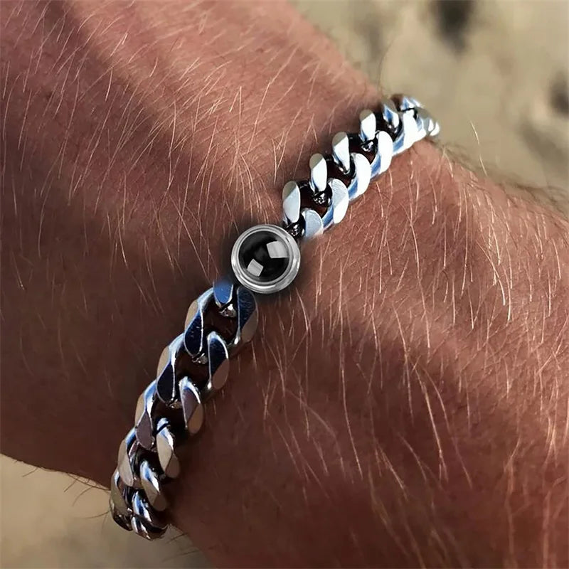 Silver chain bracelet on a wrist with a blurred background