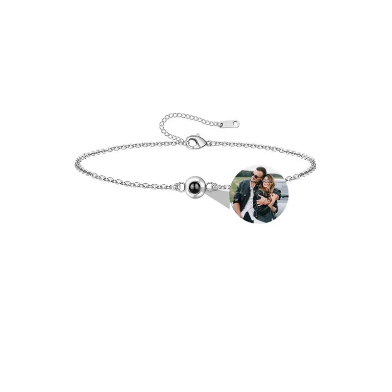 Silver bracelet with a heart-shaped photo charm on a white background