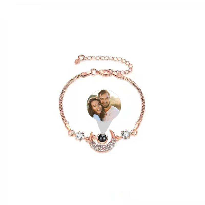 Rose gold bracelet with heart-shaped photo charm on a white background