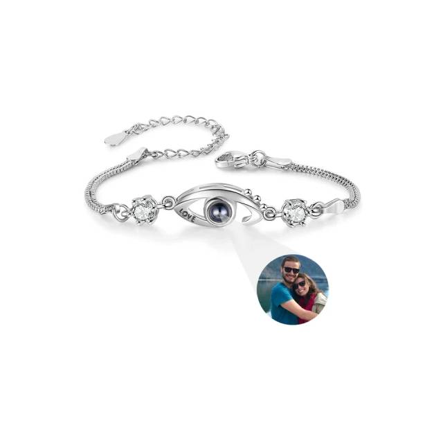 Silver bracelet with a photo charm on a white background