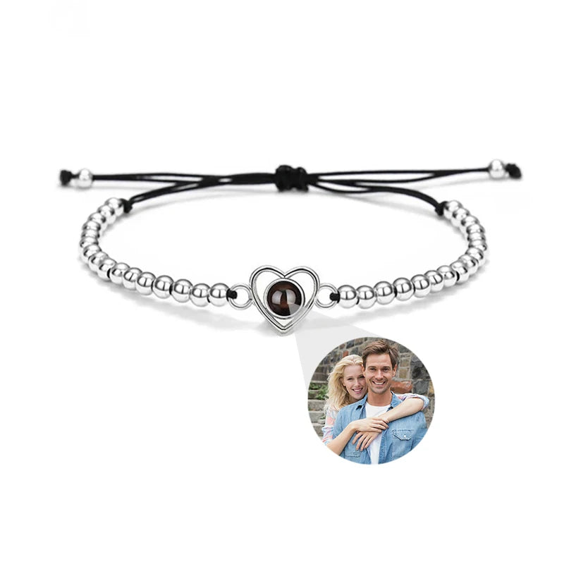 Bracelet with heart-shaped charm featuring a photo of a couple on a white background