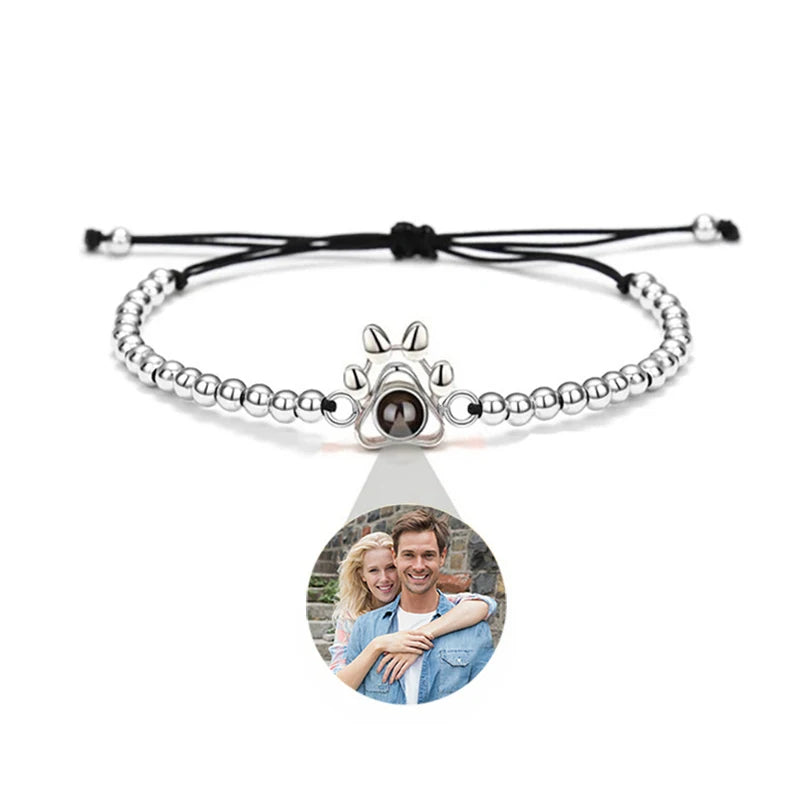 Silver beaded bracelet with a photo charm on a white background