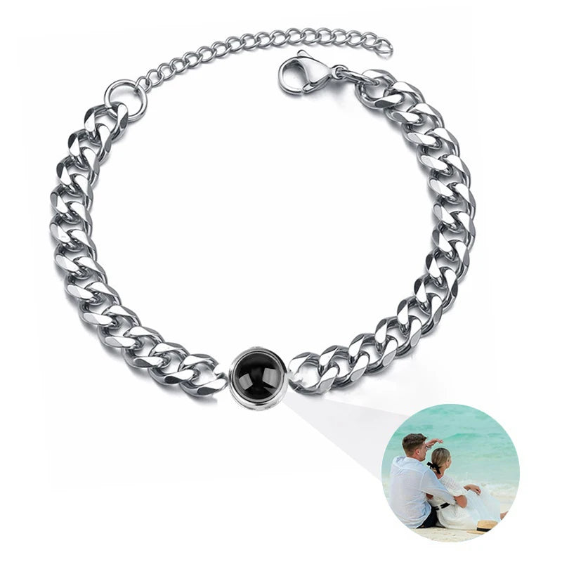 Silver chain bracelet with a black stone on a white background