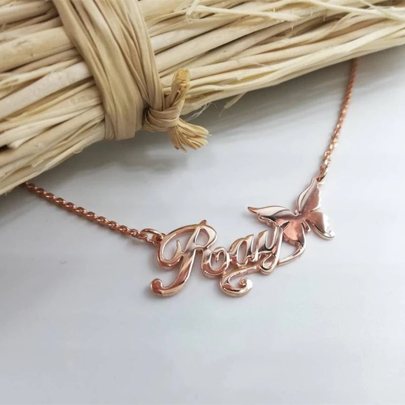 Rose gold necklace with 'Roxy' pendant on a light background