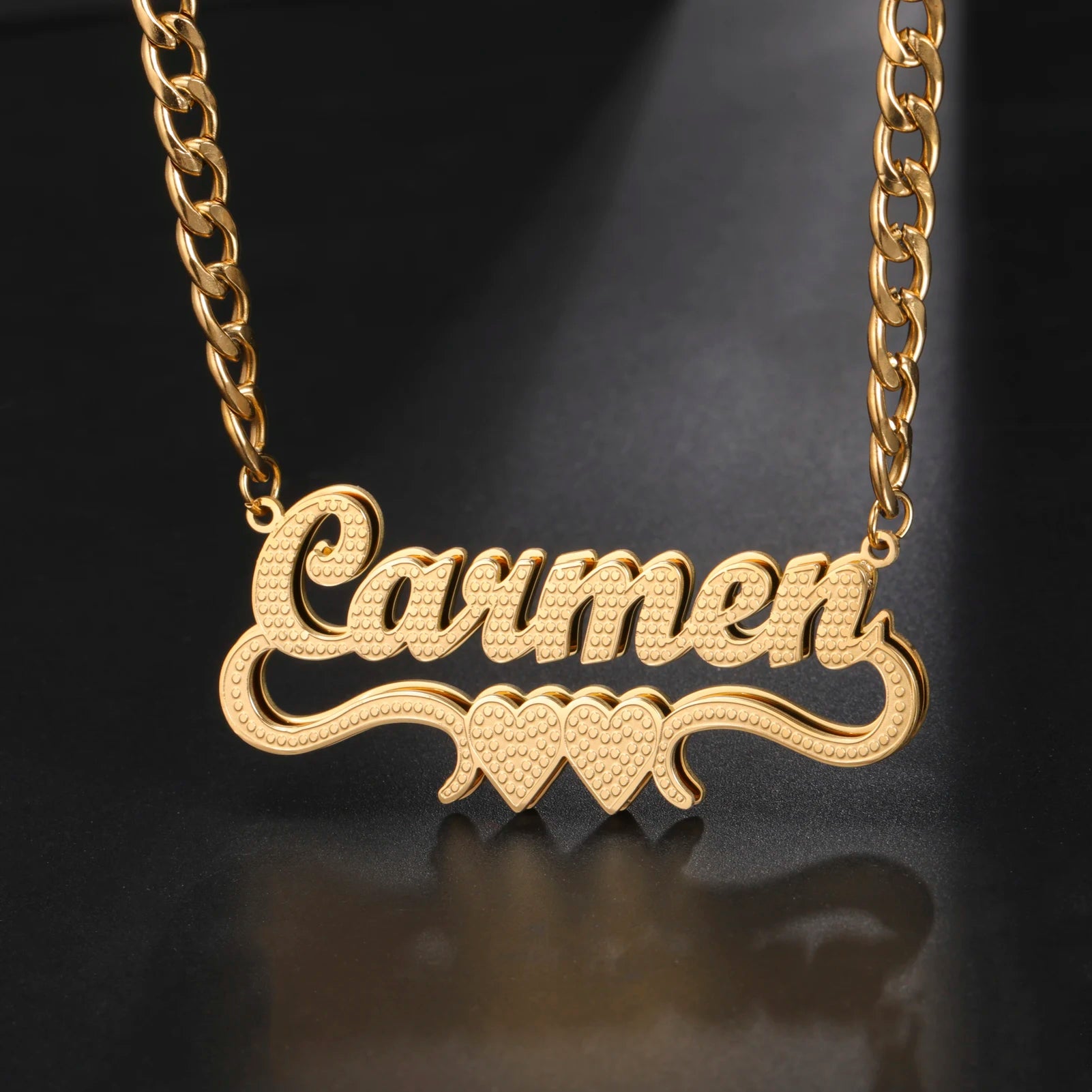 Gold necklace with 'Lauren' pendant on a dark background