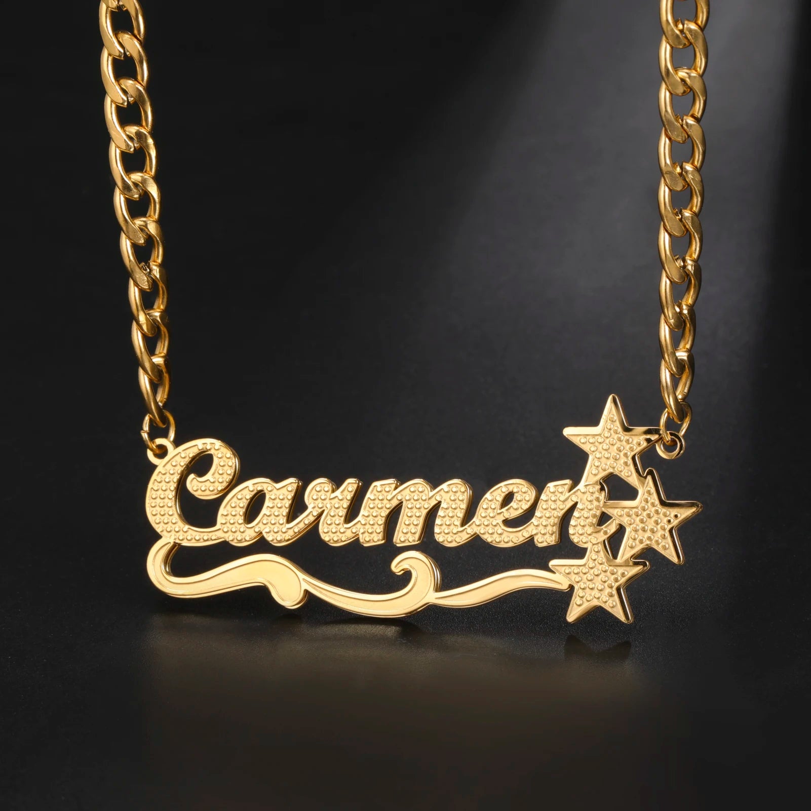 Gold necklace with 'Carmer' pendant on a black background