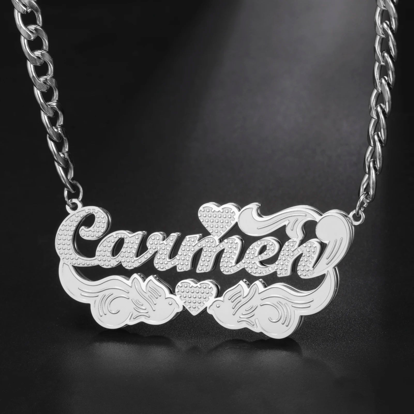 Silver necklace with 'Carmen' pendant on a dark background