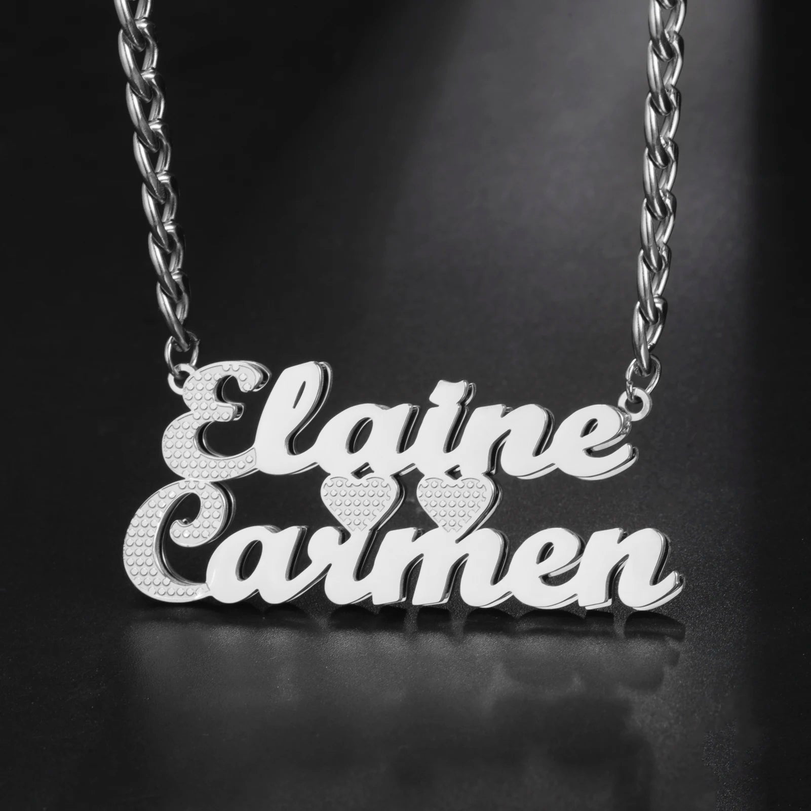 Silver name necklace with 'Elaine Carman' on a dark background