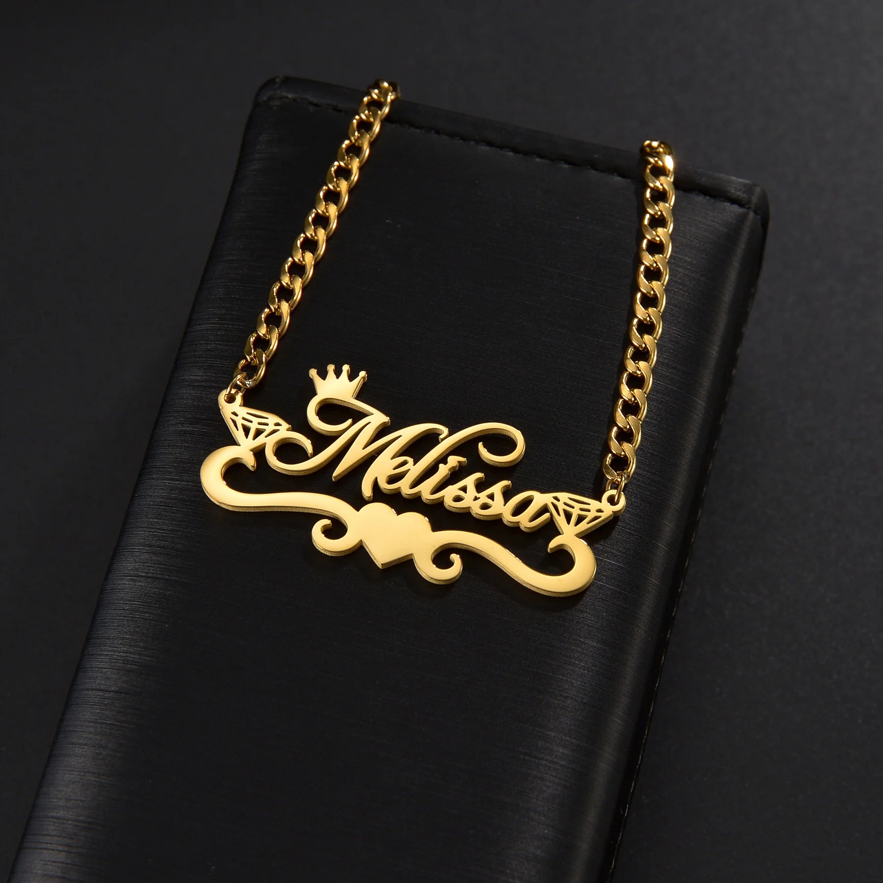 Gold necklace with 'Melissa' pendant on a black background