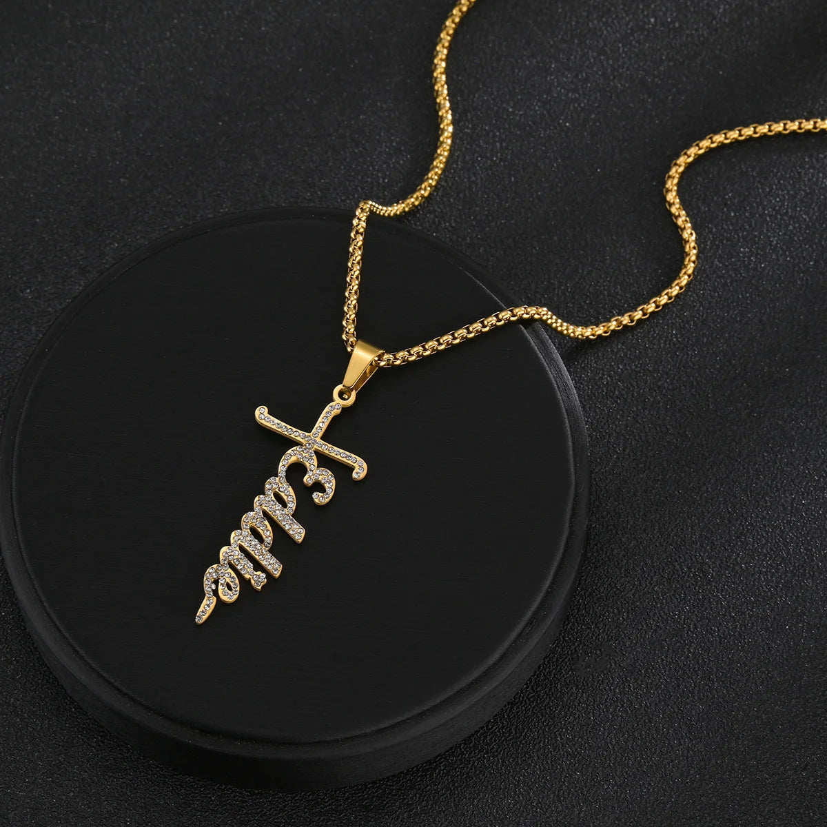 Gold necklace with a unique pendant on a black background
