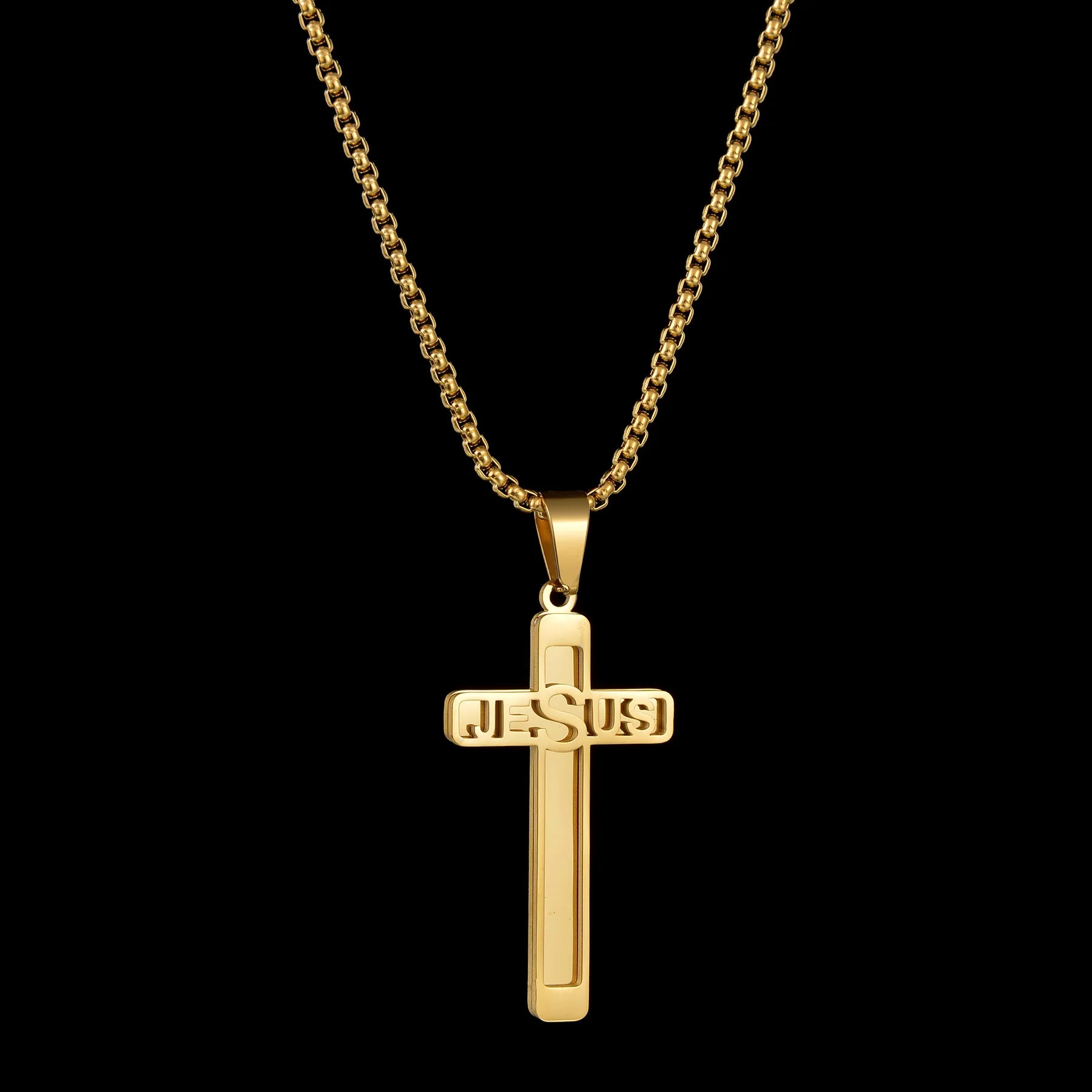 Gold cross pendant necklace with 'JESUS' engraving on a black background