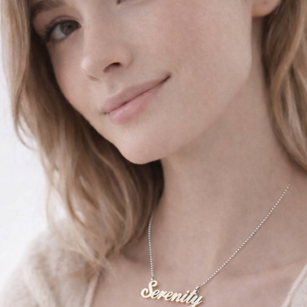 Close-up of a woman wearing a 'Serenity' necklace on a plain background