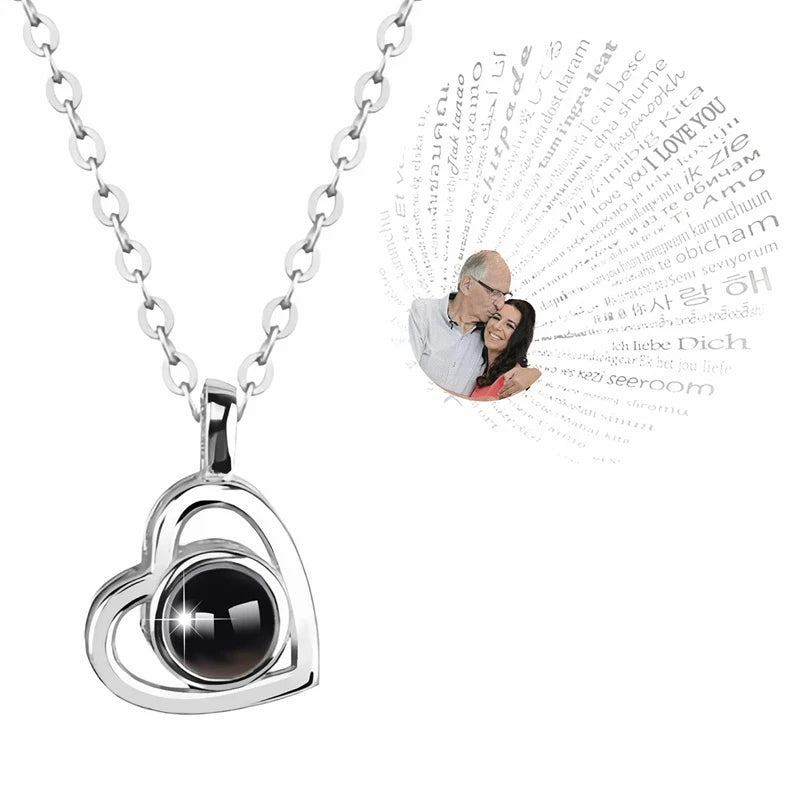 Heart-shaped pendant necklace with a black stone on a white background