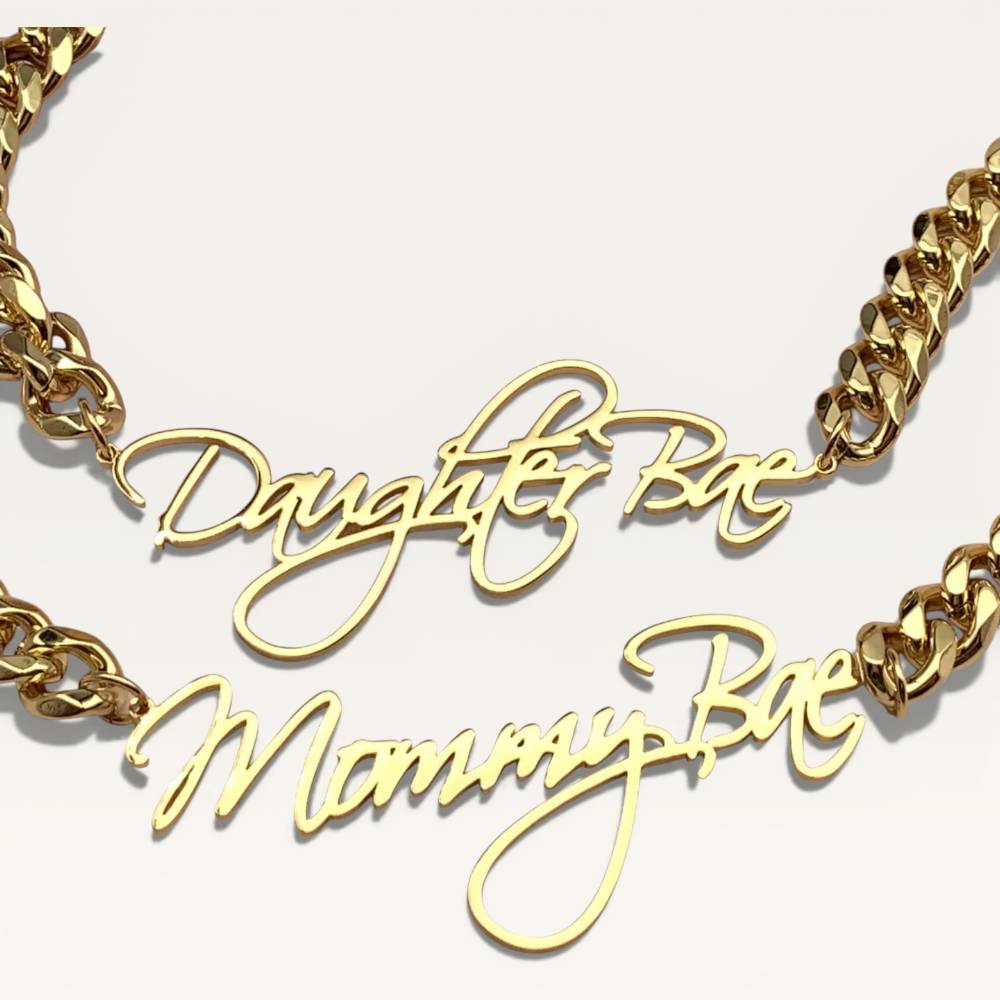 Gold chain necklace with 'Daughter Bae' and 'Mommy Bae' pendants on a white background