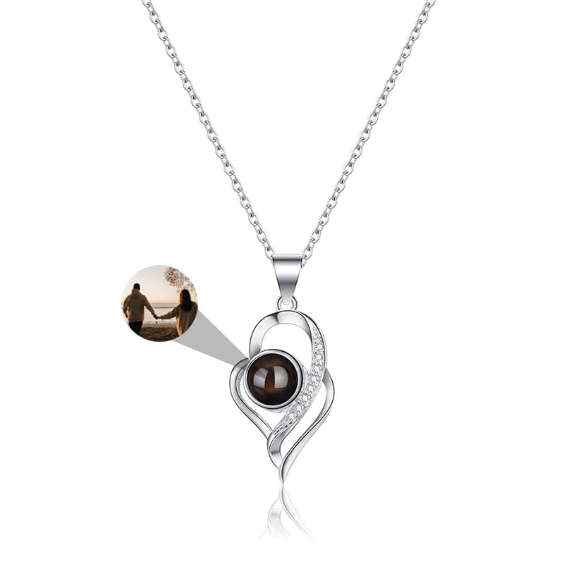 Silver necklace with a dark brown gemstone on a white background