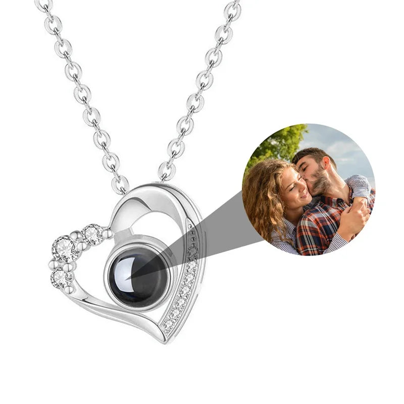 Heart-shaped necklace with a photo inset of a couple hugging