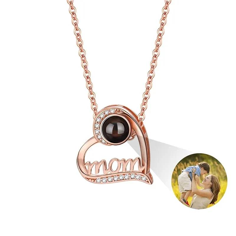 Rose gold necklace with 'mom' pendant and photo insert on a white background