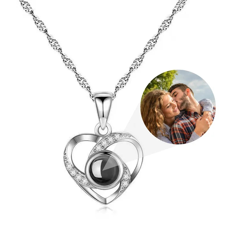 Heart-shaped silver pendant necklace with a photo of a couple inset on a white background