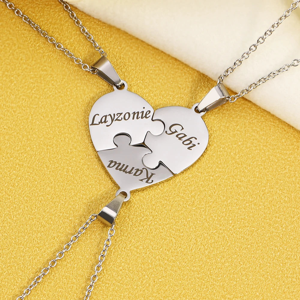 Heart-shaped puzzle piece necklace with engraved names on a yellow background