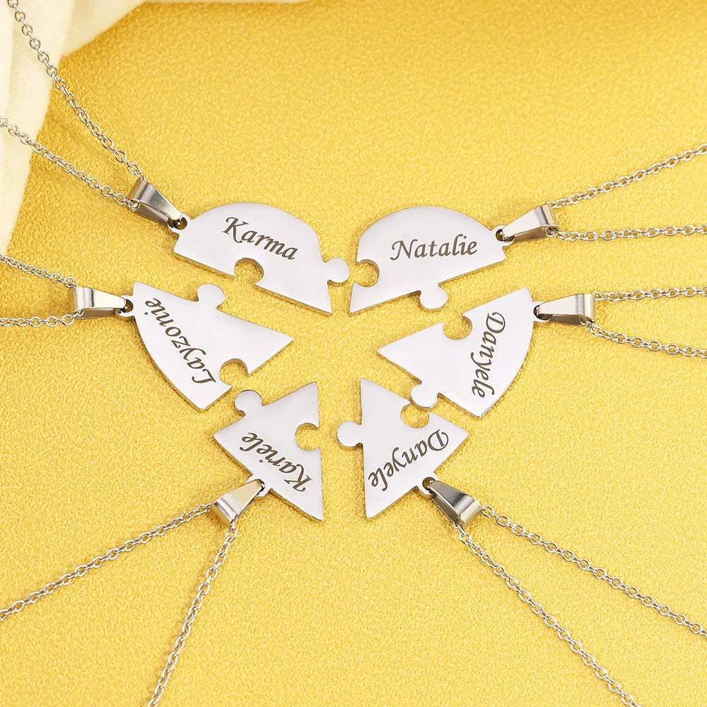 Silver puzzle piece necklaces with names engraved on a yellow background
