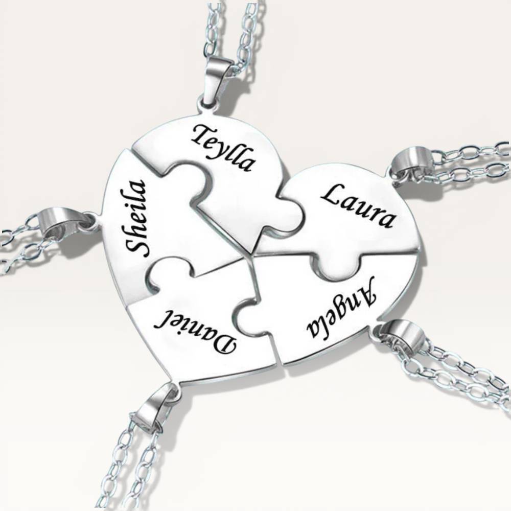 Silver puzzle piece necklace with engraved names on a white background