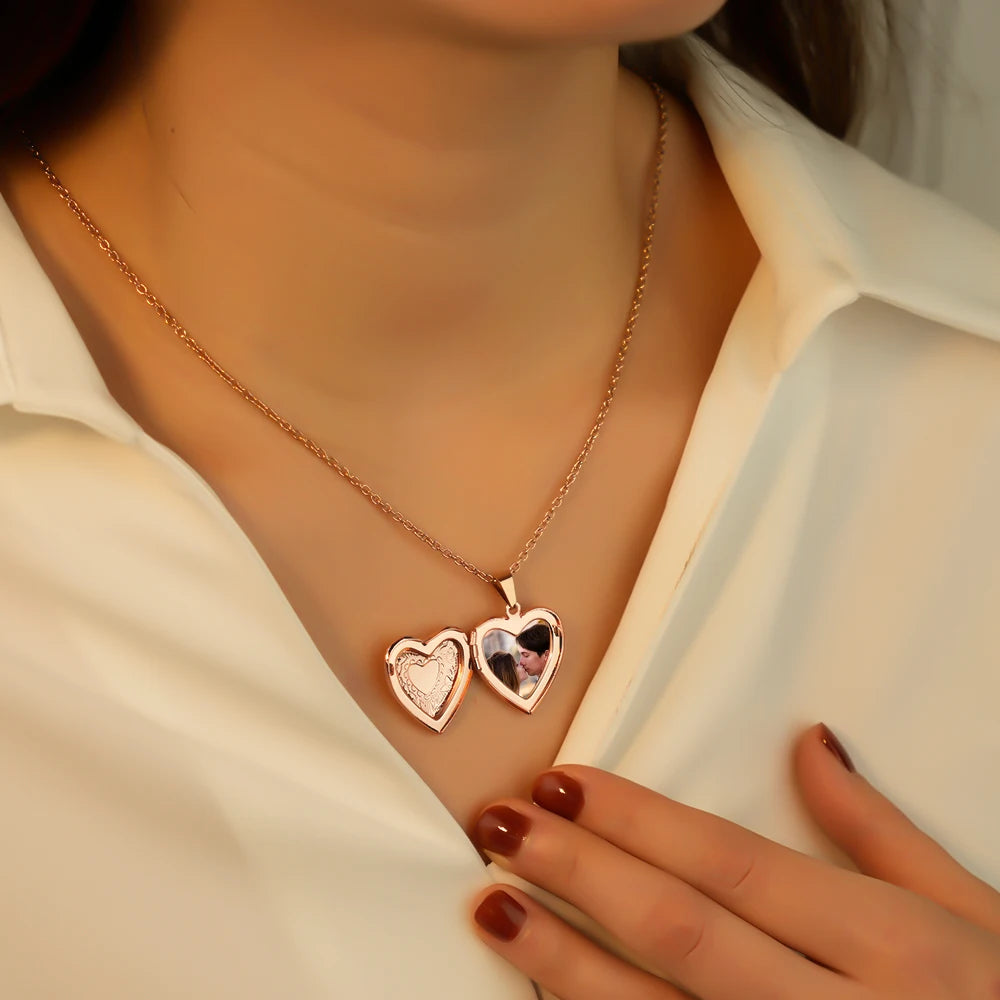 Rose gold heart-shaped necklace worn by a person with a blurred background