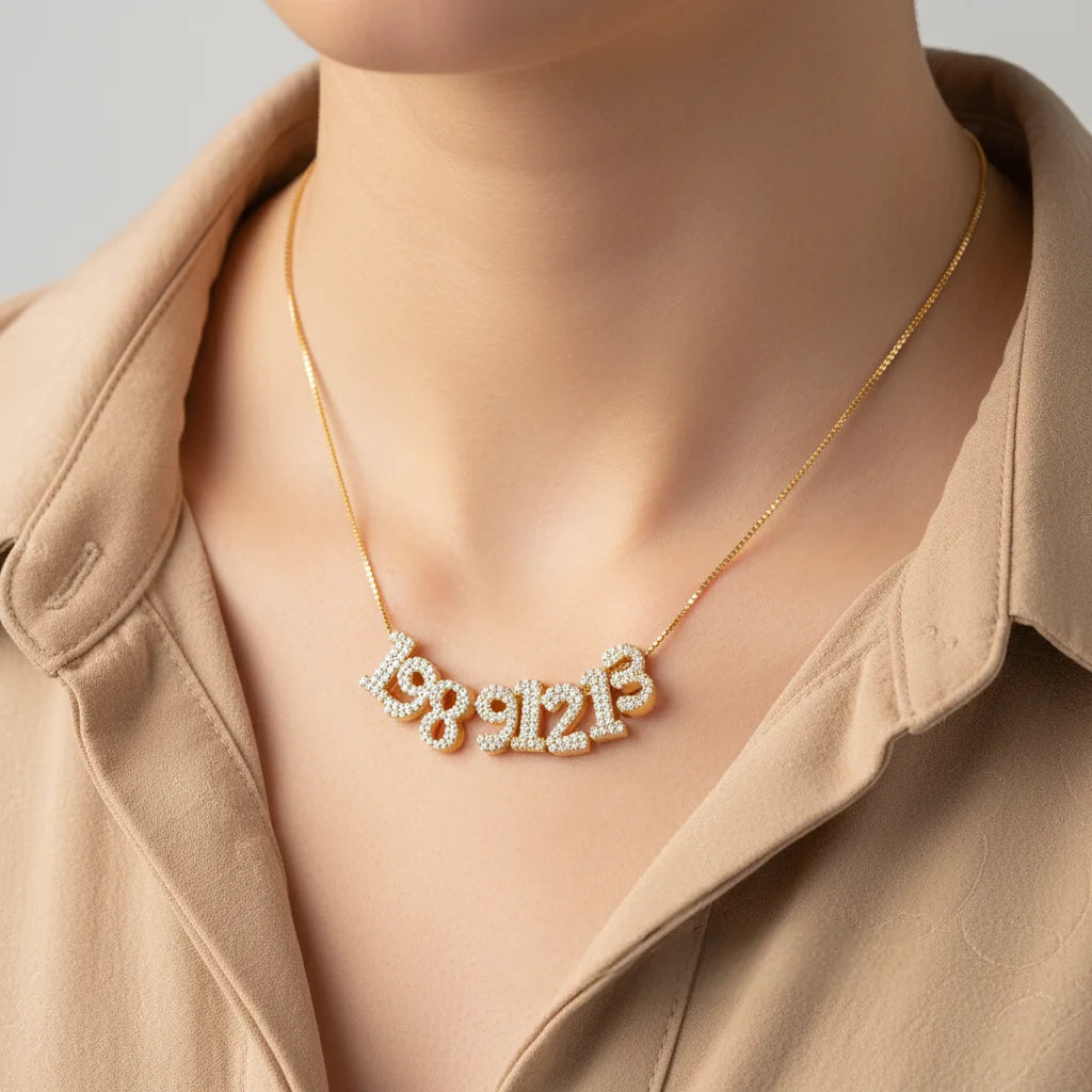 Necklace with diamond-encrusted numbers on a mannequin wearing a beige coat.